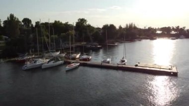 Kherson, Ukraine - June 6th 2026: Video of yachts swaying peacefully on the waves at the pier on the Dnieper River near Kherson. High quality FullHD footage