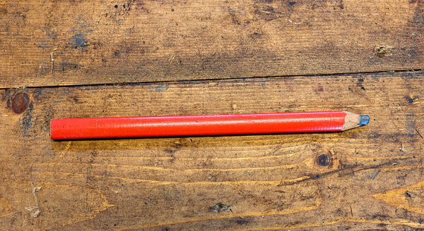 red pencil on dirty working bench in workshop Sweden 2022