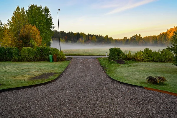 Early foggy morning over garden with gravel runway Kumla Sweden october 4 2022