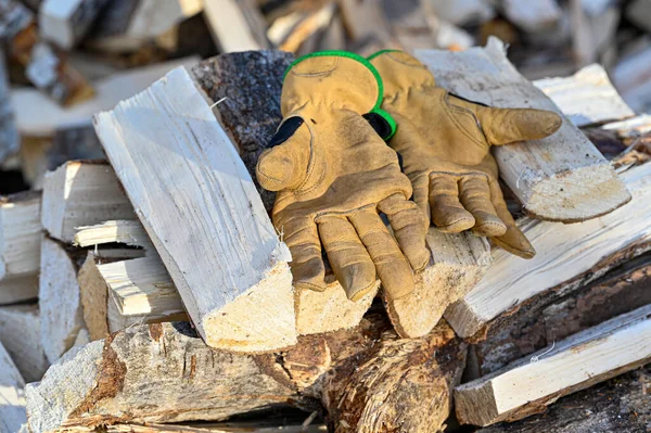 working gloves in leather on pile of firewood november 12 2022