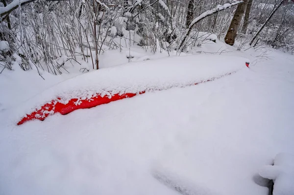 red kayak covered in snow in garden Kumla Sweden december 16 2022