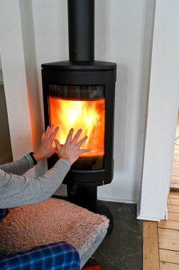 person holding up hands infront of warm stowe Sweden january 2023