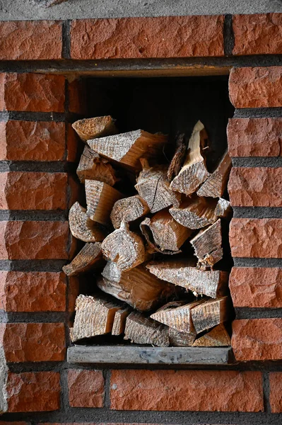 stock image fireplace made of bricks with piled firewood Sweden june 30 2023