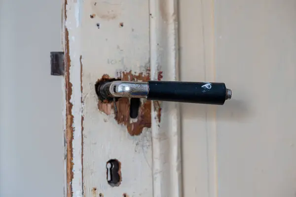 Old inner door with worn handle and lock Sweden January 15 2024