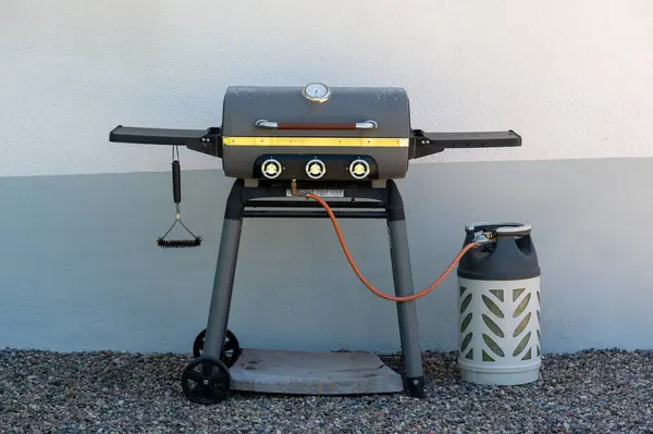 stock image Gas grill and gas cylinder in back garden Kumla Sweden June 21 2024