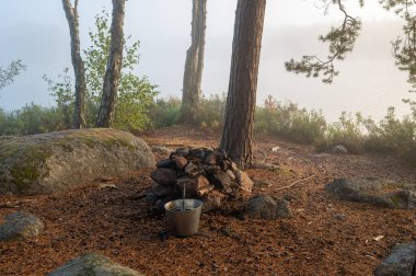 Camping site near water with small fireplace Motala Sweden October 4 2024 clipart