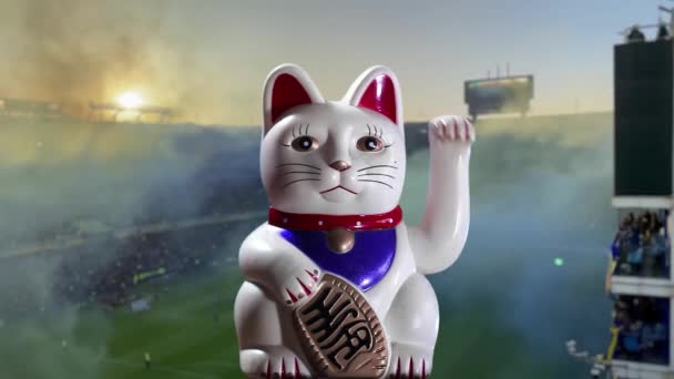 Maneki Neko Cat Vagy Beckoning Cat Blurred Soccer Stadium — Stock videók