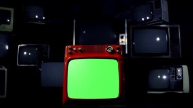 Old Red TV with Green Screen Against Many Retro TVs Fading To Black. Blue Tone. Dolly Shot. 4K Resolution.