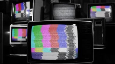 Retro TV Turning On Chroma Key Green Screen Among Many Vintage Televisions with Static Noise and Test Pattern Signal. Close Up. Black and White Tone. 
