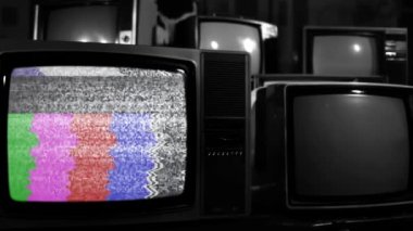 Old Television Turning On Chroma Key Green Screen Among Many Old Vintage Televisions. Black and White Tone. You can replace green screen with the footage or picture you want. You can do it with Keying effect in After Effects.