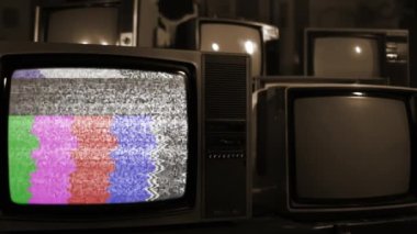 Old Television Turning On Chroma Key Green Screen Among Many Old Vintage Televisions. Sepia Tone. Close Up. You can replace green screen with the footage or picture you want. You can do it with Keying effect in After Effects (check out tutorials). 