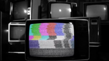 Old Television Turning On Chroma Key Green Screen Among Many Old Vintage Televisions. Black and White Tone. Close Up. Zoom In.  