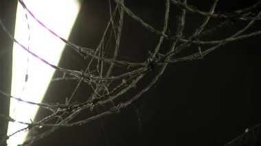 Barbed Wire on Top of Prison Fence in a Corridor of an Old Maximum Security Prison. Close Up. 