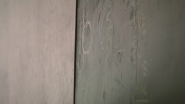 Hand of a Male Teacher Showing an Electrical Diagram on Green Chalkboard during An Education Class for Prisoners in an Argentine Prison. Close Up.  