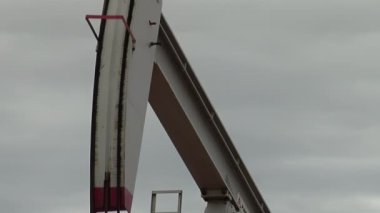 Pumpjack operating at an Oil Well near Plaza Huincul, Neuquen Province, Patagonia, Argentina. Close Up.  