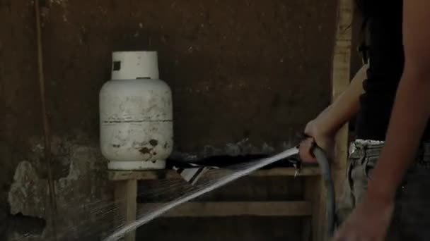 Young Woman Holding Hosepipe Watering Plants Home Domestic Gas Canister — Vídeo de Stock
