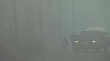 Silhouette of People and Old Pick up Truck on a Rural Road during a Foggy Morning in Varvarco, Neuquen Province, Argentina.  