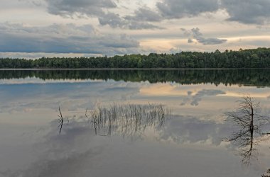 Reflections on Calm Waters in the Twilight on Clark Lake in the Sylvania Wilderness in Michigan