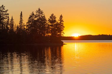 Orange Skies in the Great North Woods on Kekekabic Lake in the Boundary Waters Canoe Area in Minnesota clipart