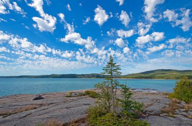 Puffy Clouds Over a Great Lakes Bay at Neys Provincial Park in Ontario clipart