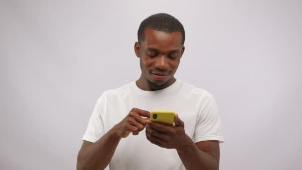 Overjoyed African American Man Smartphone Money Rain White Background Receiving — Stok video