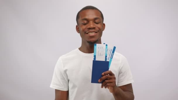 Overjoyed African American Man Showing Two Airline Tickets White Background — стоковое видео