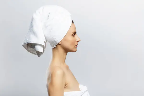 stock image Beautiful and sexy woman wearing white towel on her head. Sensuality, wellness and spa concept.