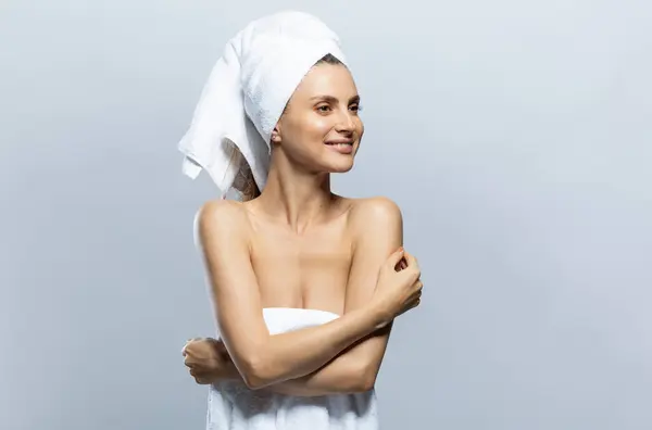 stock image Beautiful and sexy woman wearing white towel on her head and around her body. Sensuality, wellness and spa concept.