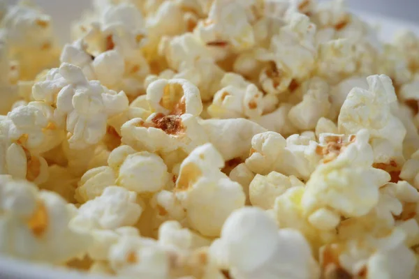 Popcorn background, Sweet popcorn top view, Tasty heap of salted popped popcorn, closeup