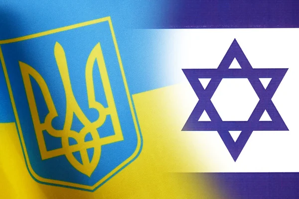 Ukraine and Israel flags, blue and yellow Ukrainian flag and half Israel flag, concept, closeup