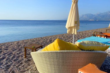 Beach Chairs and Sun Umbrella on a beautiful sea coast. Holiday concept, outdoors