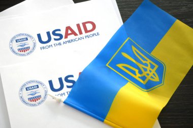 Kiev, Ukraine - 02 12 2023: USAid logo and ukrainian flag, USAid is USA agency for international development - assistance abroad