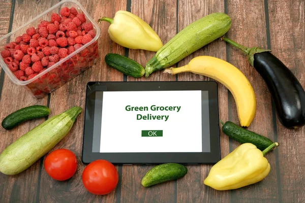 Organic Vegetables and fruits in cotton bag and tablet pc with copy space, online market, green grocery delivery at home concept