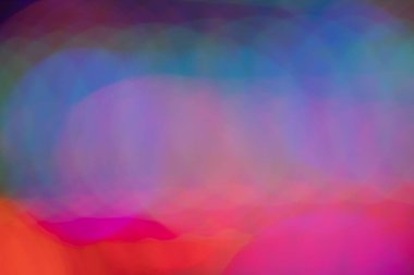 Abstract intentional blur multi-colored background. A high-quality photo of out-of-focus lights with intentional camera movement. 