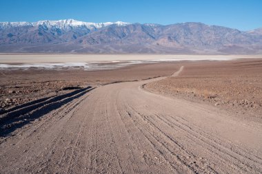 Dirt road in Death Valley California. High quality photo of the Panemint range in Death Valley National Park. 