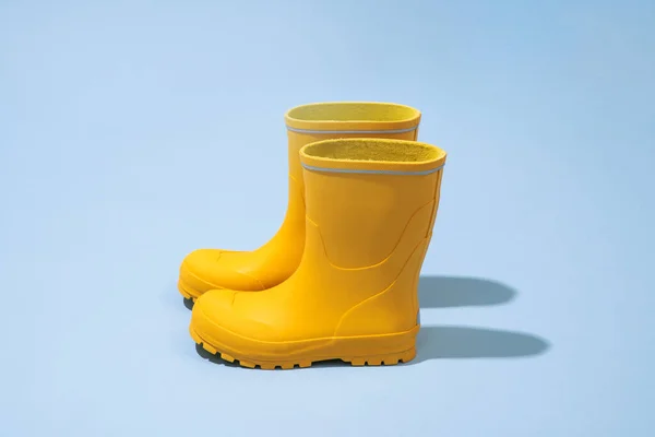 stock image Yellow rubber boots isolated on blue backgroun