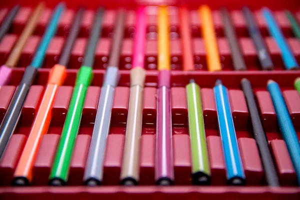 felt-tip pens in a box. Colored pencils background and texture