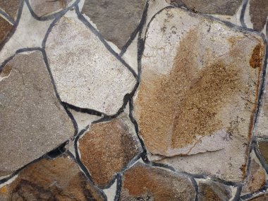 Doğal taş dokusunun fotoğrafı. Duvarın dokusu doğal taştan yapılmış.