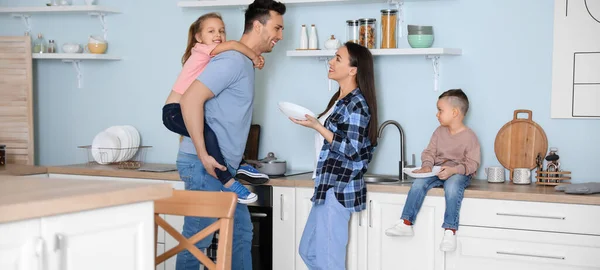 stock image Young family washing dishes in kitchen