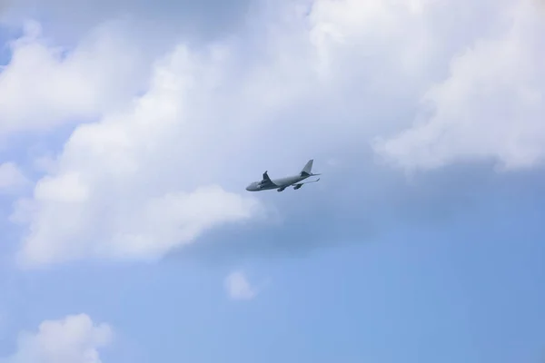 Stock image Modern airplane flying in blue sky