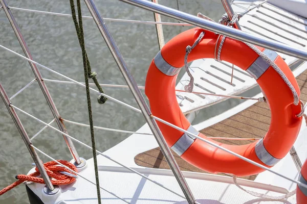 Modern yacht with ring buoy at pier, closeup