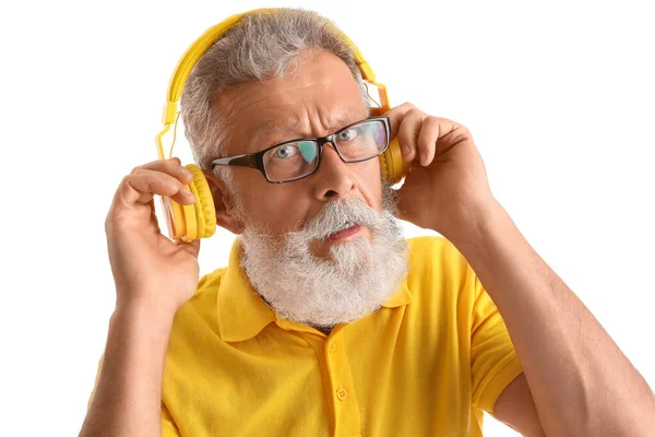 戴着白色背景耳机和特写镜头的老年男子困惑不已 — 图库照片