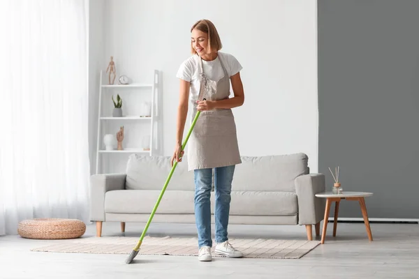 Young Housewife Mopping Floor Home — Stockfoto