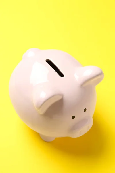 Piggy bank on yellow background. Money saving concept