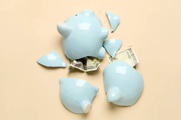 stock image Broken piggy bank with money on color background. Money saving concept