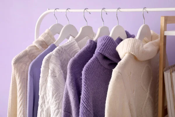 Rack Knitted Sweaters Lilac Wall Closeup — Stock Photo, Image