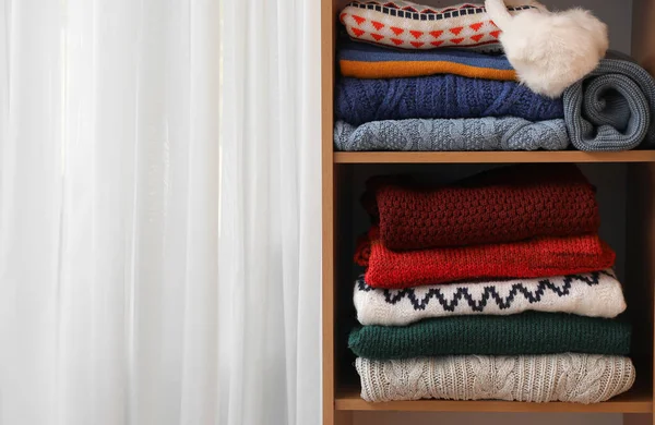 Shelving Unit Folded Sweaters Light Curtain Closeup — Stock Photo, Image