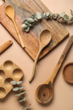 Ahşap mutfak aletleri ve bej arka planda okaliptüs dalları