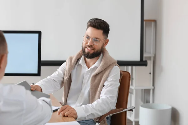 stock image Male bank manager working with his colleague at table in office