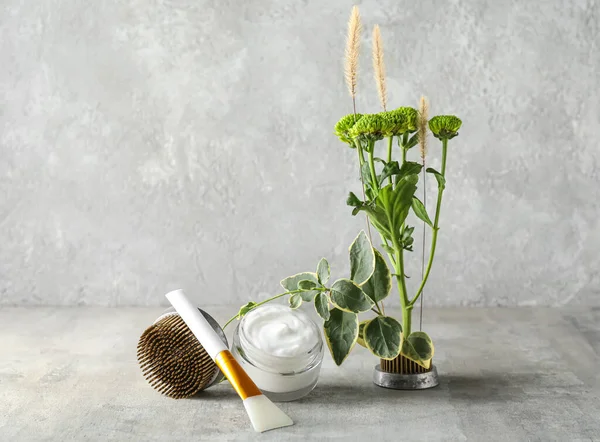 Stock image Jar of cream with brush, kenzans and ikebana on grunge background